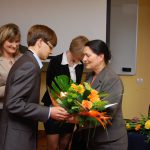 Przedstawiciel studentów wręcza kwiaty kanclerz mgr Zofii Kozioł
